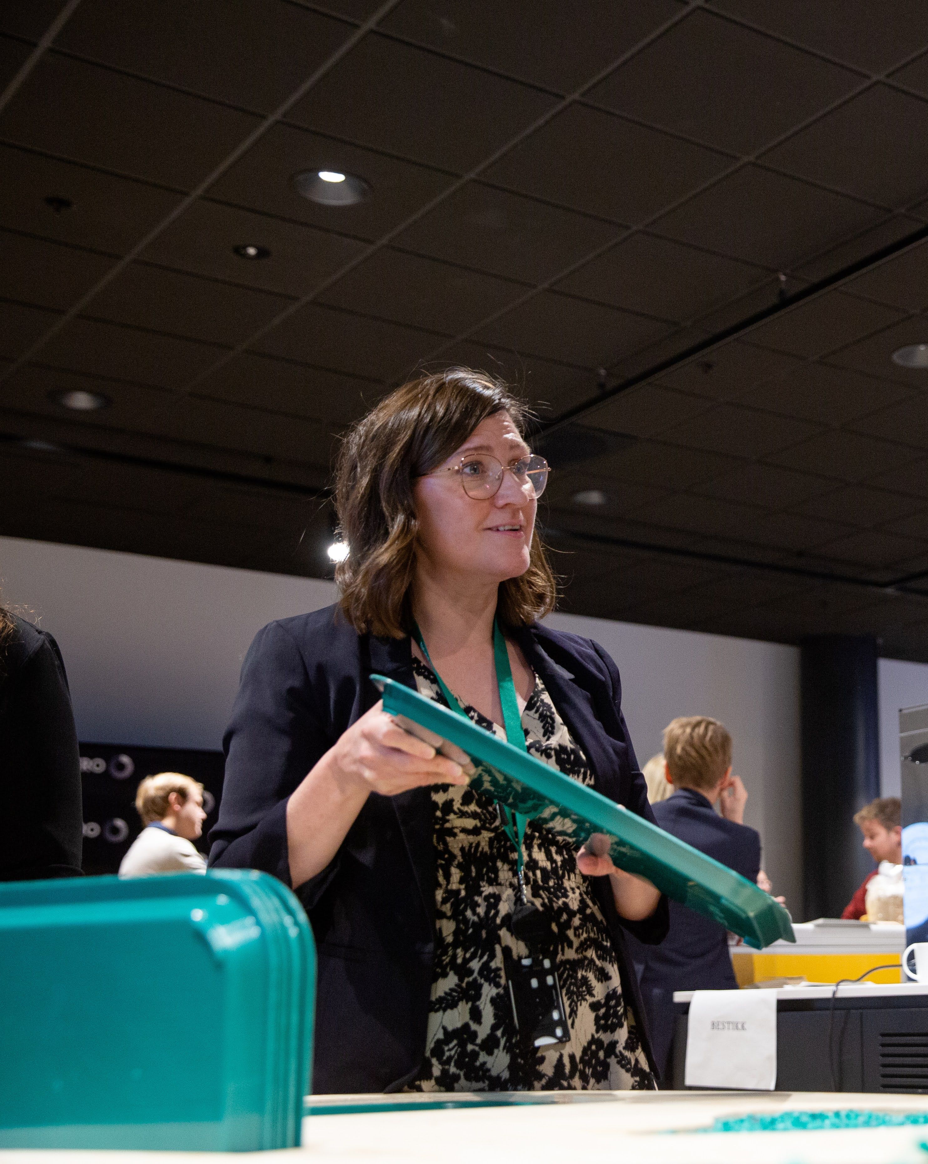Chief Circular Product Officer, Susie Jahren, showing one of AION's recycled plastic plates 